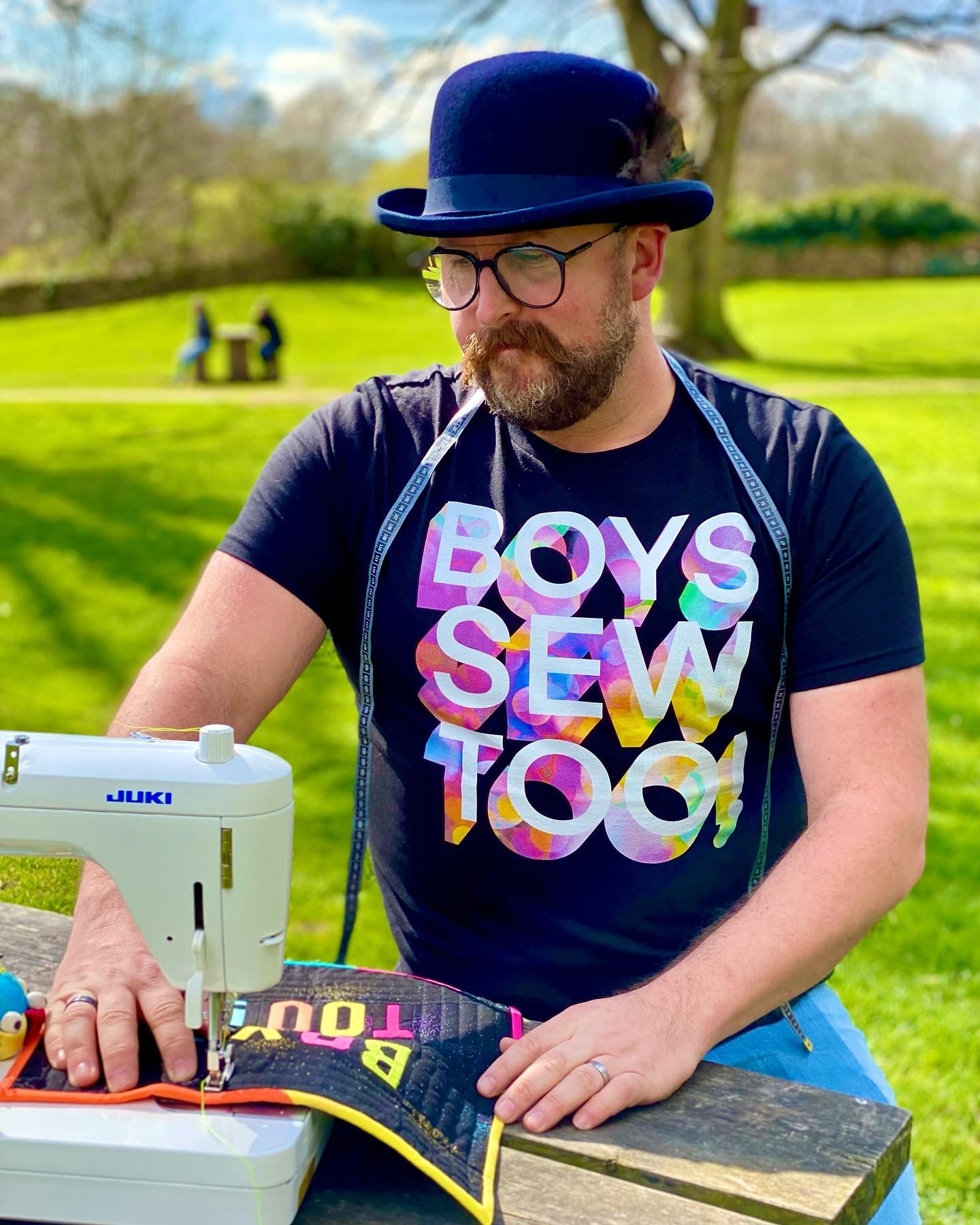 Clive with #boyssewtoo tee machine sewing in a park